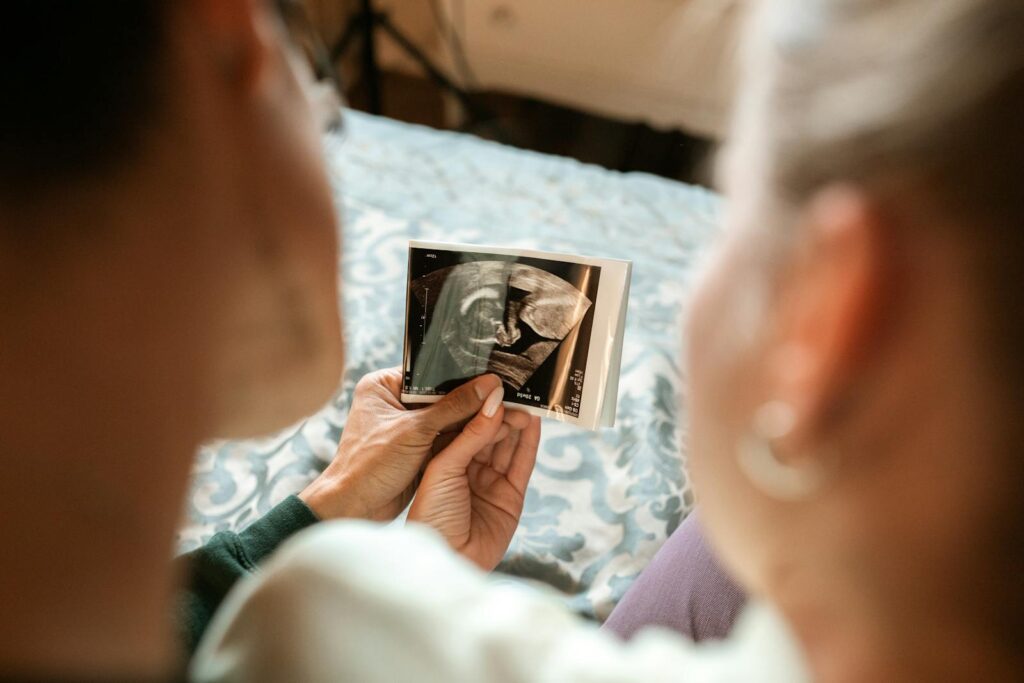 Expectant parents sharing a tender moment viewing their baby's ultrasound image.